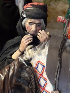 Diorama of a Lurish woman in mourning from the Ethnographic Museum inside Falak-ol-Aflak Castle. The woman wears a black headscarf and robe, has red makeup on her face. (Wikimedia / Adam Jones)