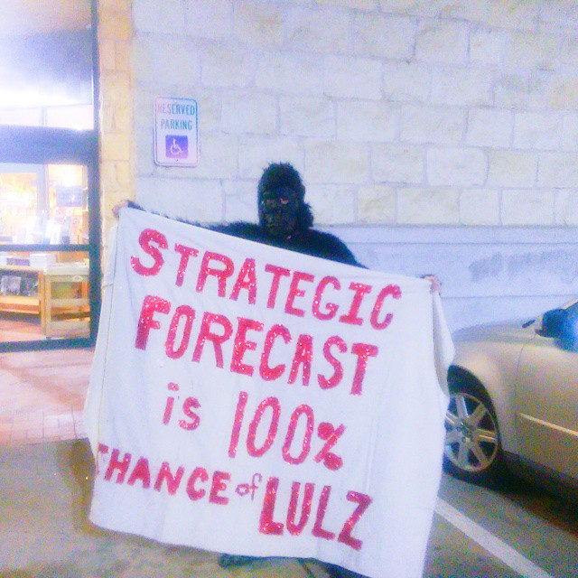 An "Anonymous gorilla" (a protester in a gorilla suit) stood outside Book People in Austin, Texas on February 2, 2015 during George Friedman's book signing. The gorilla's banner reads Strategi Forecast Is 100% Chance Of Lulz. (Kit O'Connell)