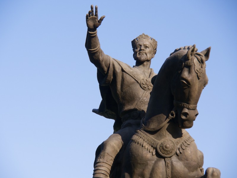 A statue of the conquering warlord Timur, riding a horse with one arm outstretched in a regal pose, photographed in  Amir Timur Square in Uzbekistan on April 29, 2013. The events that Timur and his armies set in motion eventually led to the rulership of Döndü Hatun in Baghdad and the Djelâyir state of the medieval Middle East. (Flickr / Fang-Yu Lin)