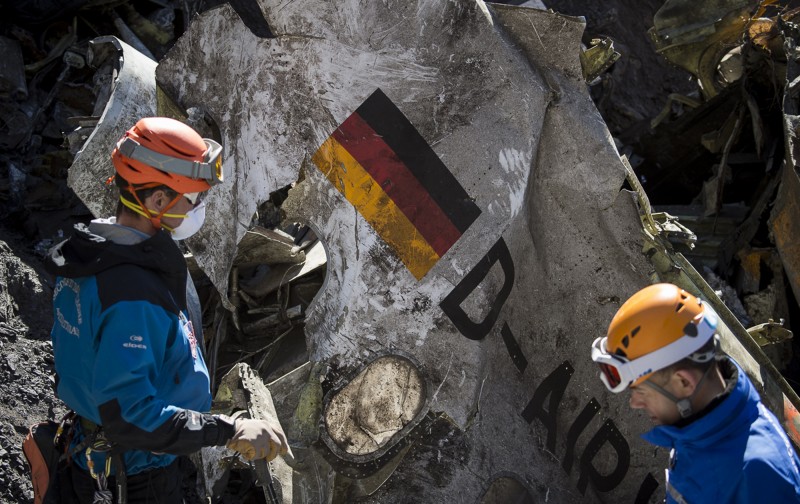 In this photo taken on Tuesday, March 31, 2015 and provided by the French Interior Ministry, French emergency rescue services work among debris of the Germanwings passenger jet at the crash site near Seyne-les-Alpes, France. Comparing the treatment of the killer Germanwings pilot Andreas Lubitz to that of France's "terrorist" Muslim killers reveals much about the mainstream media's assumptions and prejudices. (AP Photo/Yves Malenfer, Ministere de l'Interieur)