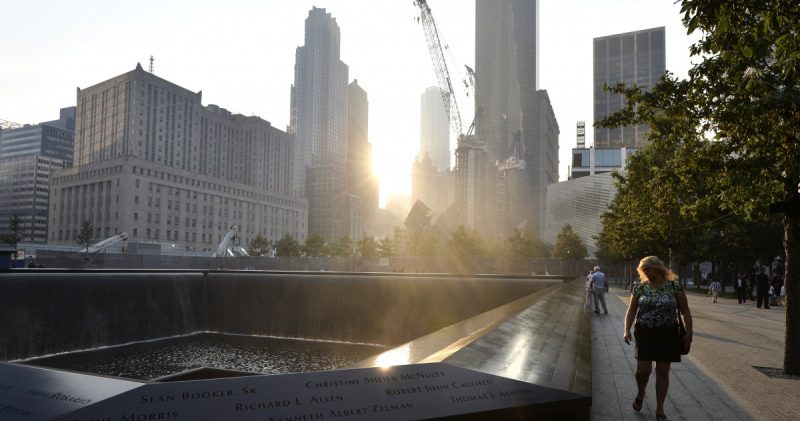 A woman walks along the edge of the North Pool at the 9/11 Memorial during a ceremony marking the 12th anniversary of the 9/11 attacks on the World Trade Center, in New York, Wednesday, Sept. 11, 2013. (AP Photo/Justin Lane, Pool)