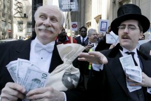 Protesters dressed as wall street bankers, march from Goldman Sachs' office to a rally demanding Wall Street reform. (AP/M. Spencer Green)