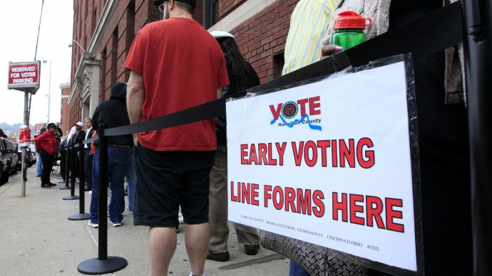 In this Oct. 2, 2012 file photo, voters stand in line outside the Hamilton County Board of Elections just before it opened for early voting, in Cincinnati. (AP Photo/Al Behrman, File)