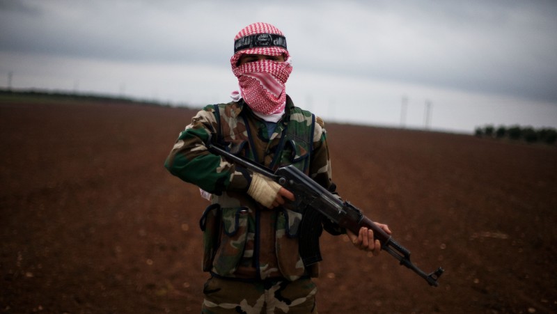 A Free Syrian Army fighter takes position close to a military base, near Azaz, Syria, Monday, Dec. 10, 2012. (AP Photo/Manu Brabo)