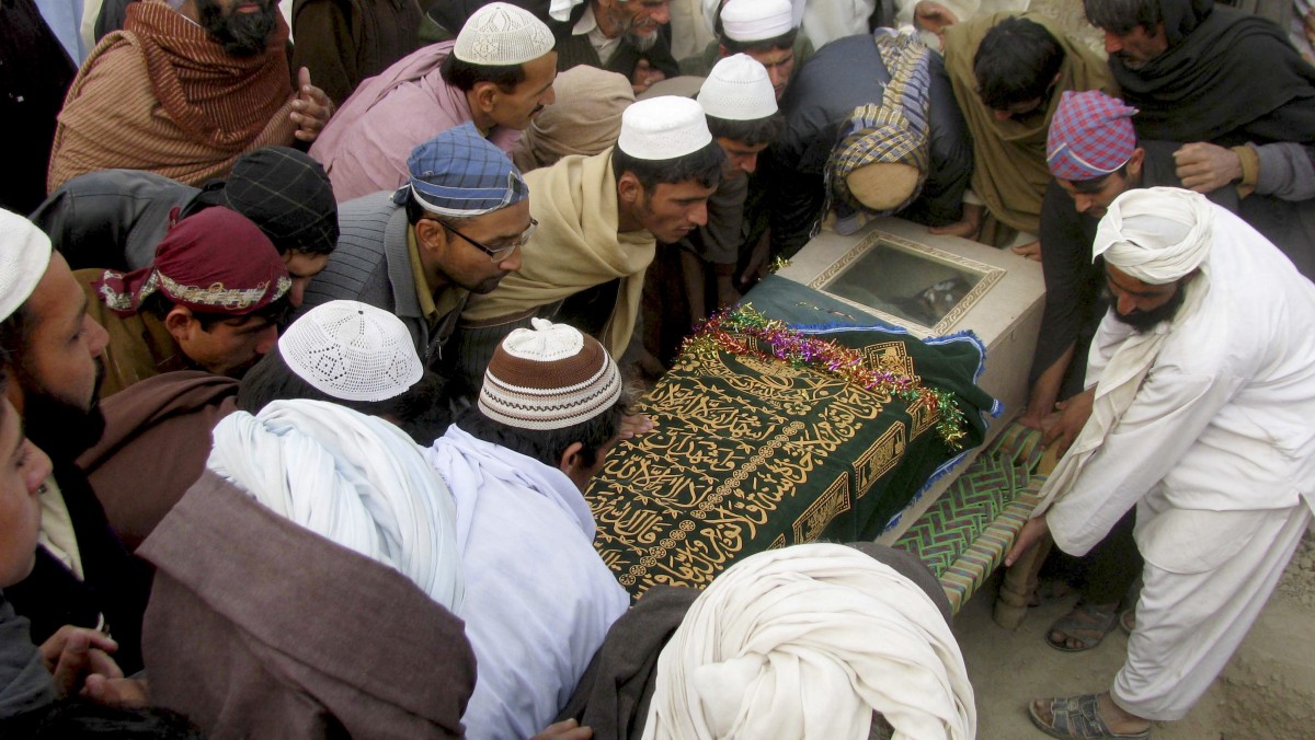 In this Dec. 29, 2010, file photo, Pakistani villagers carry the shrouded casket of a person reportedly killed by a US drone attack in Pakistani tribal area of Mir Ali along the Afghanistan border, during his funeral in Bannu, Pakistan. (AP Photo/Ijaz Muhammad, file)