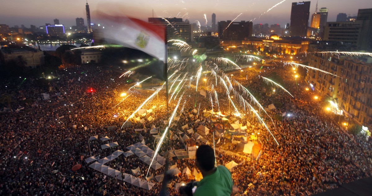 An Egyptian protester waves a national flag as Egyptians gather in Tahrir Square during a demonstration against President Mohammed Morsi in Cairo, Sunday, June 30, 2013. (AP/Amr Nabil)