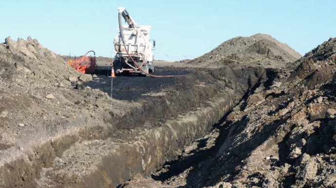 In this Oct. 8, 2013 photo provided by the North Dakota Health Department, a vacuum trucks cleans up oil in near Tioga, N.D. The North Dakota Health Department says more than 20,000 barrels of crude oil have spewed out of a Tesoro Corp. oil pipeline in a wheat field in northwestern North Dakota. Officials say the 20,600-barrel spill, among the largest recorded in the state, was discovered on Sept. 29 by a farmer harvesting wheat about nine miles south of Tioga. (AP Photo/North Dakota Health Department)