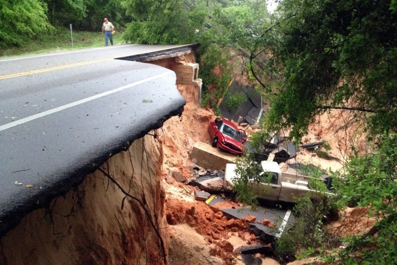 Vehicles lie at the bottom of a ravine after the Scenic Highway collapsed near Pensacola, Fla., Wednesday April 30, 2014. (AP Photo/Pensacola News Journal, Katie E. King) AP10thingsToSee - Vehicles lie at the bottom of a ravine after the Scenic Highway collapsed near Pensacola, Fla., Wednesday April 30, 2014. Nearly 2 feet of rain drenched Escambia and Santa Rosa counties in the span of about 24 hours. (AP Photo/Pensacola News Journal, Katie E. King)