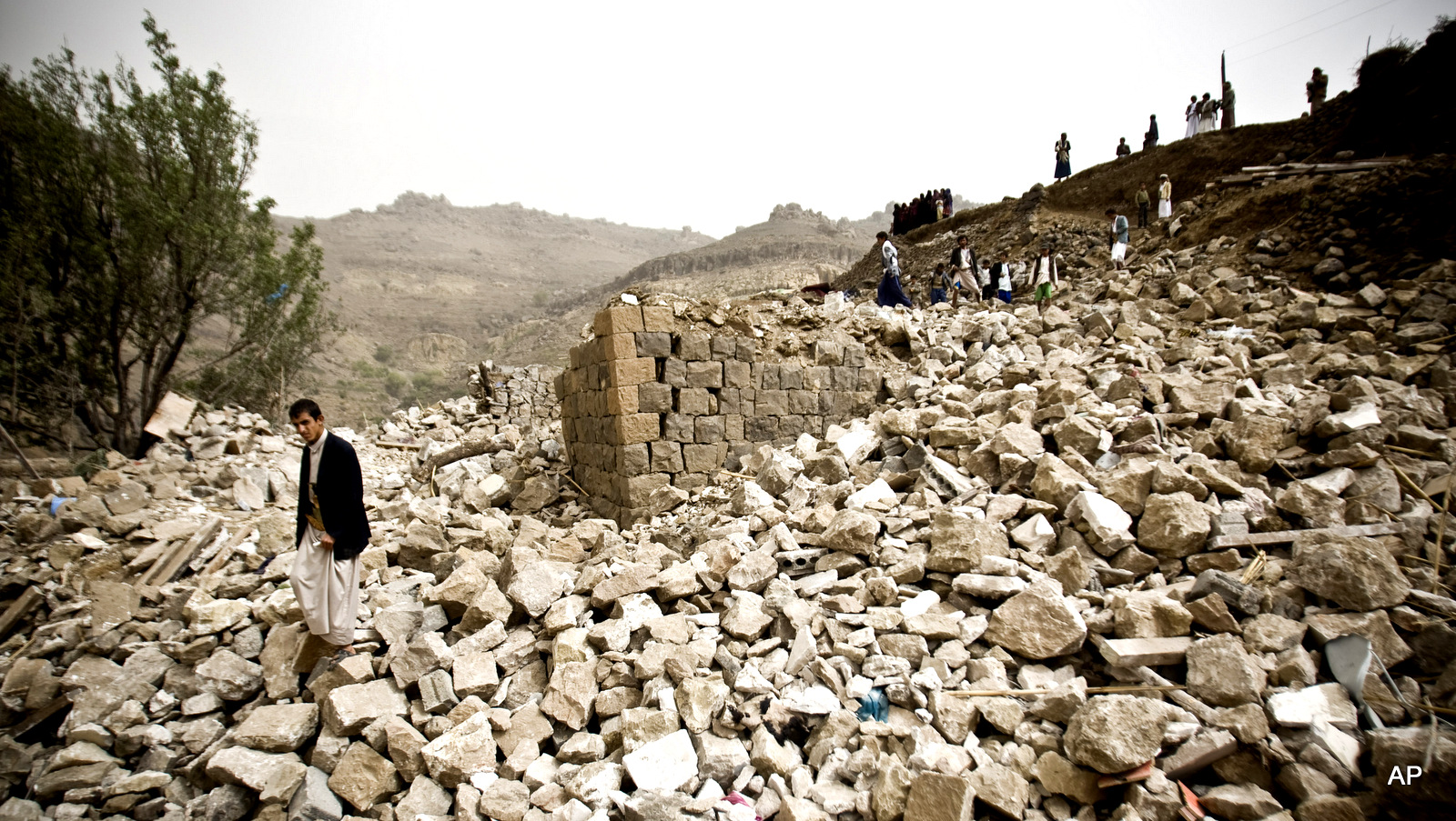 Yemenis search for survivors in the rubble of houses destroyed by Saudi-led airstrikes in a village near Sanaa, Yemen.