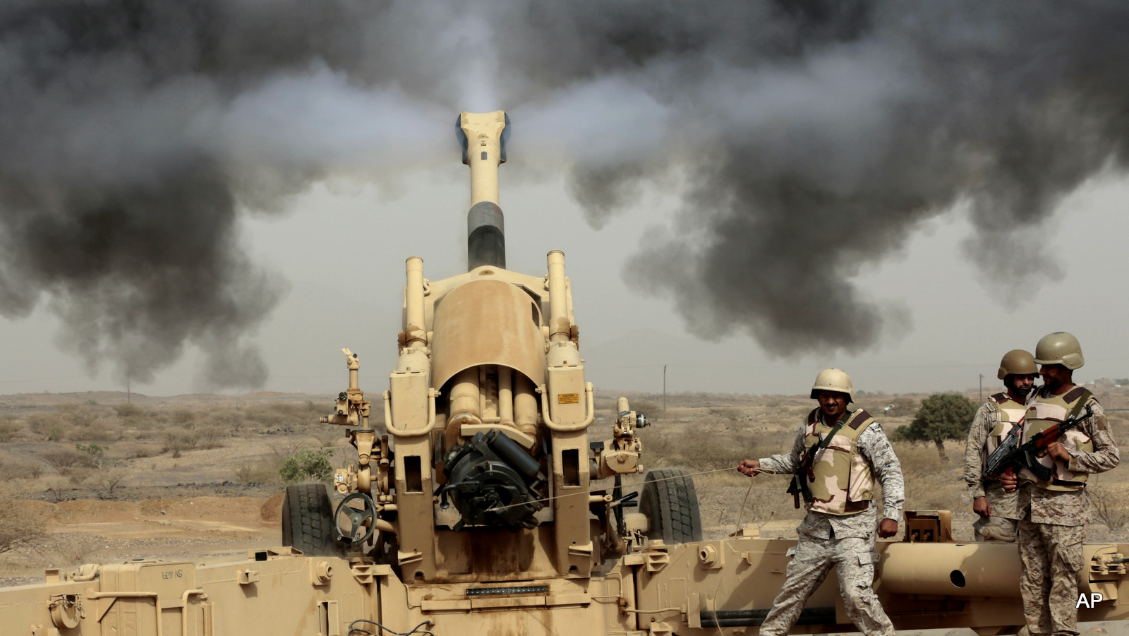Saudi soldiers fire artillery toward three armed vehicles approaching the Saudi border with Yemen in Jazan, Saudi Arabia, Monday, April 20, 2015. 