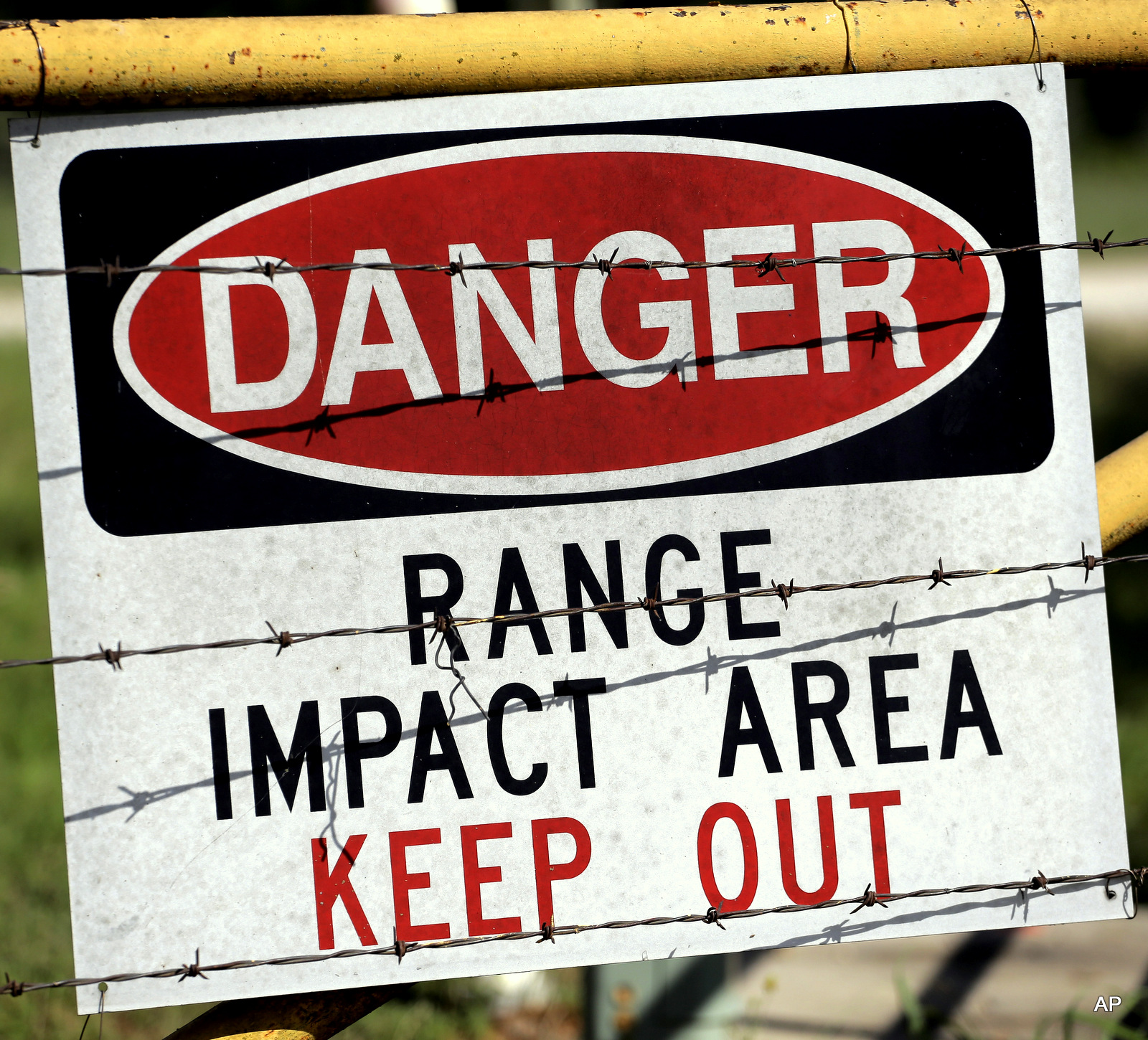 A warning sign is posted at a gate entrance at Texas Army National Guard Camp Swift, Wednesday, July 15, 2015, in Bastrop, Texas.