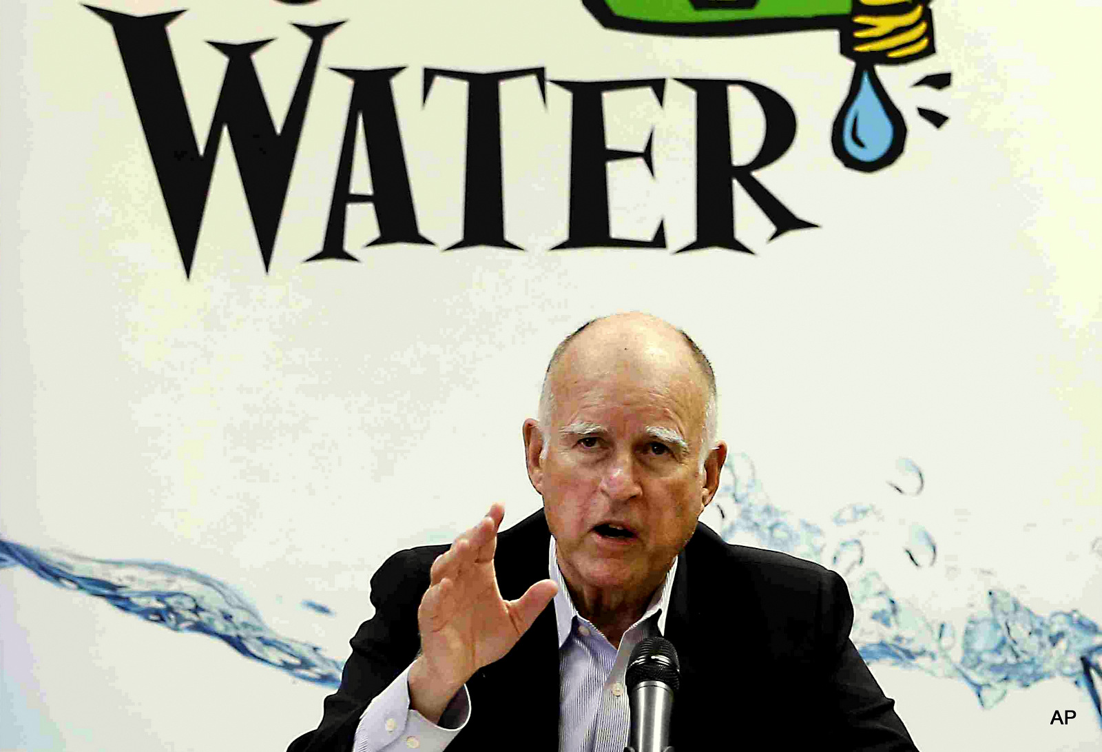 California Gov. Jerry Brown talks with reporters after a meeting about the drought