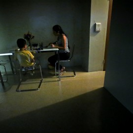 A women sits with her son for dinner in their new sparsely furnished apartment, Thursday, Aug. 13, 2015, in New York. After leaving her husband who beat her for years, she and her little boy spent the next three years homeless because she couldn’t afford New York City rents. About one third of American children are now living in poverty. (AP Photo/Bebeto Matthews)