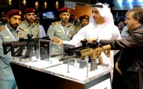 Sheikh Mohammed bin Rashid Al Maktoum, Ruler of Dubai, inspects the goods at the 2013 DSEi international arms fair.