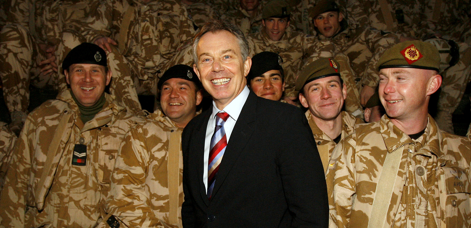 Britain's Prime Minister Tony Blair, stands with British troops in Basra, Iraq, Sunday, Dec. 17, 2006. Earlier on Sunday Blair held talks with Iraq's Prime Minister Nouri al-Maliki in Baghdad in a visit designed to show support for fragile attempts to halt Iraq's seemingly unstoppable bloodshed. Britain has some 7,000 troops in Iraq, most based around Basra in the south - the largest commitment of any country after the United States. (AP Photo/Eddie Keogh)