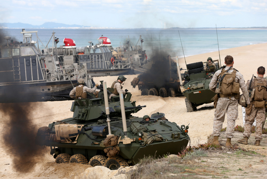 US marine armoured vehicles steers through the soft sand after getting off from a US Navy hovercraft during the NATO Trident Juncture exercise 2015 at Raposa Media beach in Pinheiro da Cruz, south of Lisbon, Tuesday, Oct. 20, 2015. NATO Allies and partner nations join forces for the next three weeks for the Alliance's Trident Juncture live military exercise involving 36,000 troops from more than 30 nations across Portugal, Italy and Spain. (AP Photo/Steven Governo)
