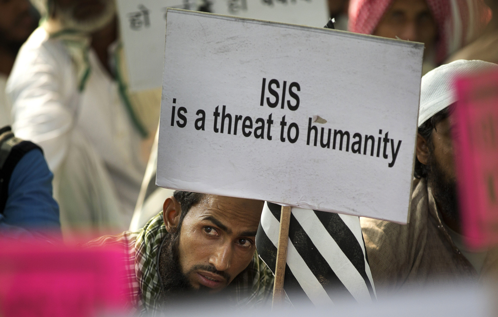 An Indian Muslim man holds a banner during a protest against ISIS, an Islamic State group, and Friday's Paris attacks, in New Delhi, India, Wednesday, Nov. 18, 2015. (AP Photo/Manish Swarup)