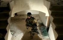 U.S. Marine Lance Cpl. Timothy Dupuis, of Dover, New Hampshire, climbs the stairs at an outpost in Fallujah, 65 kilometers (40 miles) west of Baghdad, Iraq, Tuesday, May 2, 2006.(AP Photo/Jacob Silberberg)