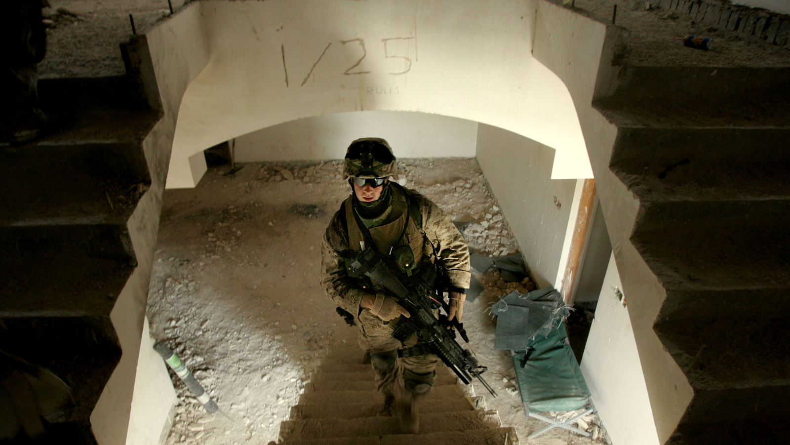 U.S. Marine Lance Cpl. Timothy Dupuis, of Dover, New Hampshire, climbs the stairs at an outpost in Fallujah, 65 kilometers (40 miles) west of Baghdad, Iraq, Tuesday, May 2, 2006.(AP Photo/Jacob Silberberg)
