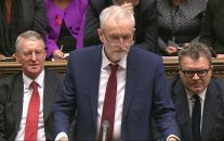 Opposition Labour Party leader, Jeremy Corbyn, centre, stands as he makes a speech to lawmakers inside the House of Commons in London, during a debate on launching airstrikes against ISIS extremists inside Syria, Wednesday, Dec. 2, 2015. Shadow Foreign Secretary Hilary Ben sitting left, and Labour Party Deputy leader Tom Watson, right. The parliamentary vote is expected Wednesday evening. (Parliamentary Recording Unit via AP Video)