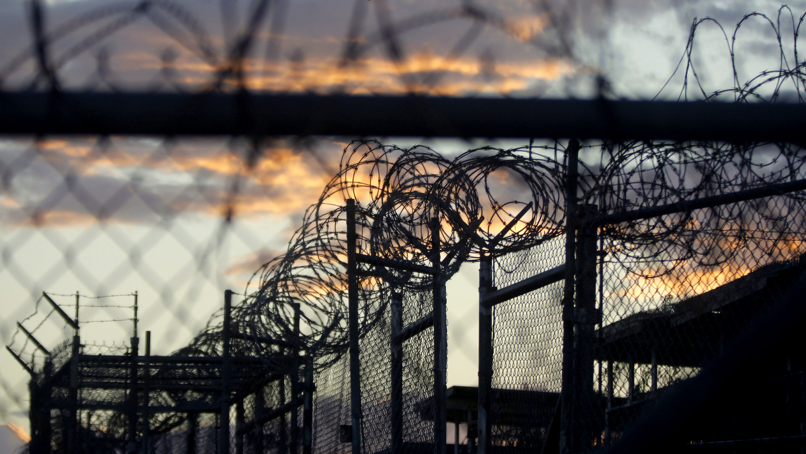 Dawn arrives at the now closed Camp X-Ray, which was used as the first detention facility at Guantanamo Bay Naval Base, Cuba. U.S. officials say the Pentagon’s long-awaited plan to shut down the detention center at Guantanamo Bay, Cuba, and transfer the remaining detainees to a facility in the U.S. calls for up to $475 million in construction costs, but would save as much as $180 million per year in operating costs. (AP Photo/Charles Dharapak)