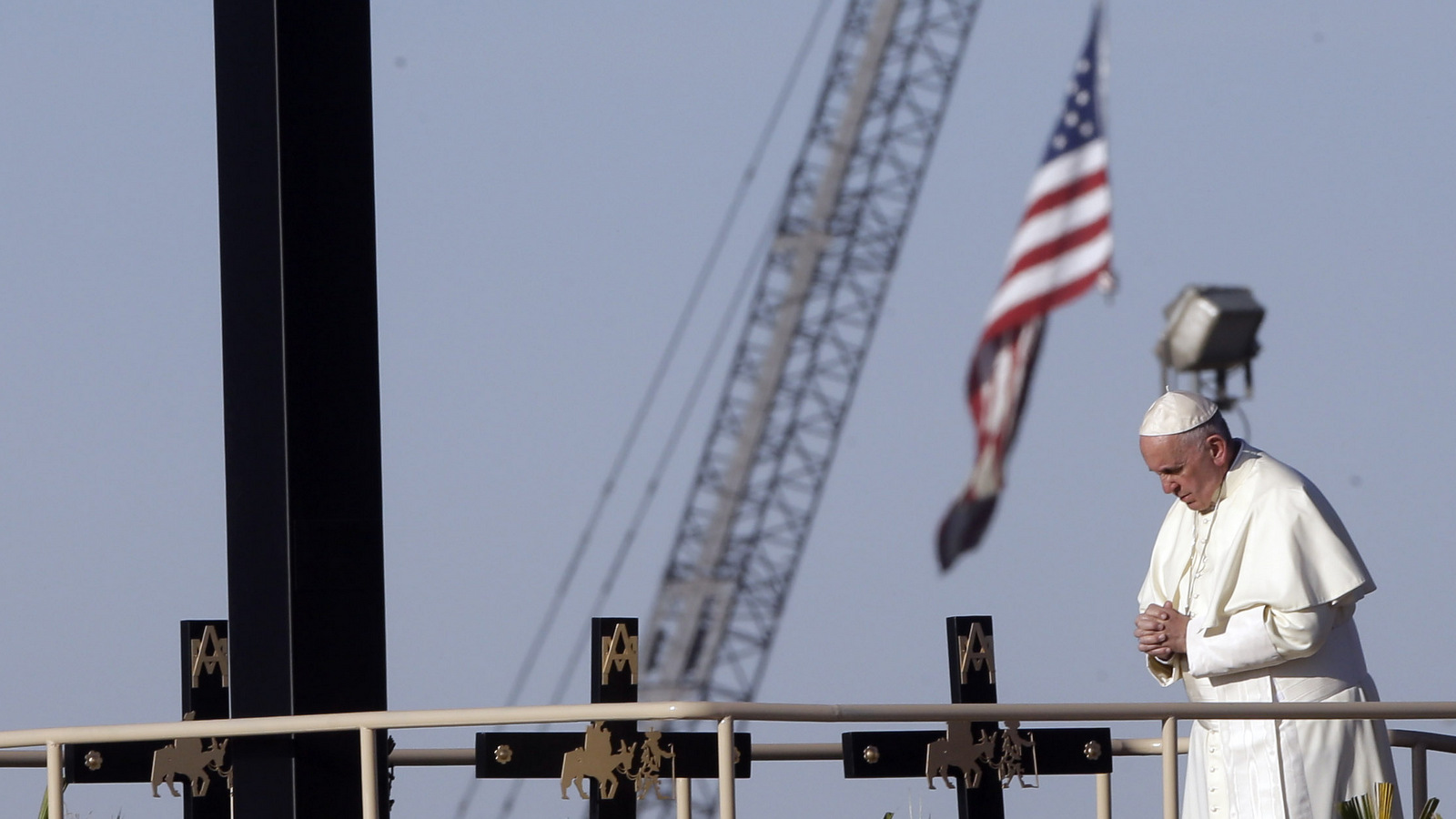 Pope Francis prays near the U.S.-Mexico border fence along the Rio Grande, in Ciudad Juarez, Mexico, Wednesday, Feb. 17, 2016. Francis made the sign of the cross and blessed hundreds of people gathered a few yards away on the U.S. side.(AP Photo/Gregorio Borgia)