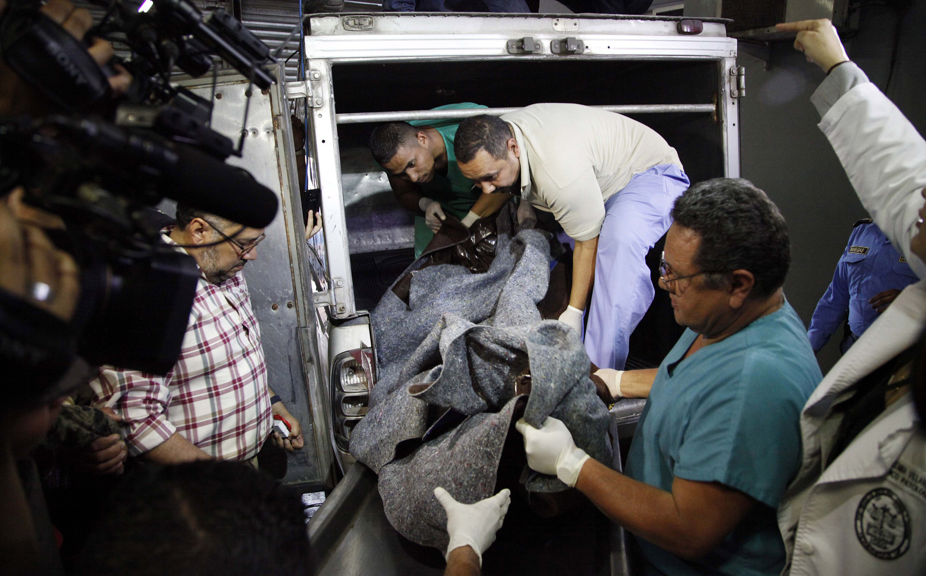 The body of slain Honduran Indian leader and environmentalist Berta Caceres is lowered from a vehicle at the coroners office in Tegucigalpa, Honduras, Thursday, March 3, 2016. Caceres, a Lenca Indian activist who won the 2015 Goldman Environmental Prize for her role in fighting a dam project, had previously complained of receiving death threats from police, soldiers and local landowners because of her work. (AP Photo/Fernando Antonio)