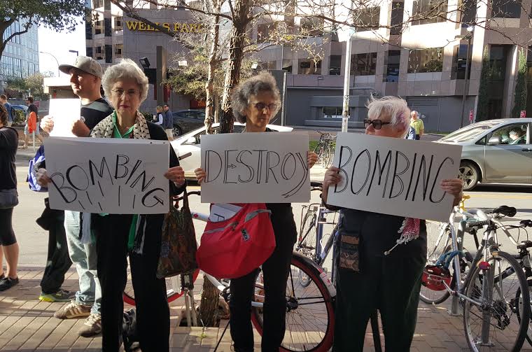 Activists hold signs reading "Bombing" and "Destroy" outside the JW Marriott hotel in Austin, Texas in this March 14, 2016 photograph. Jewish Voice For Peace organized the protest against the Israeli ambassador's appearance on the SXSW panel, "Building THe Perfect Country." Photo by Kit O'Connell for MintPress News. 