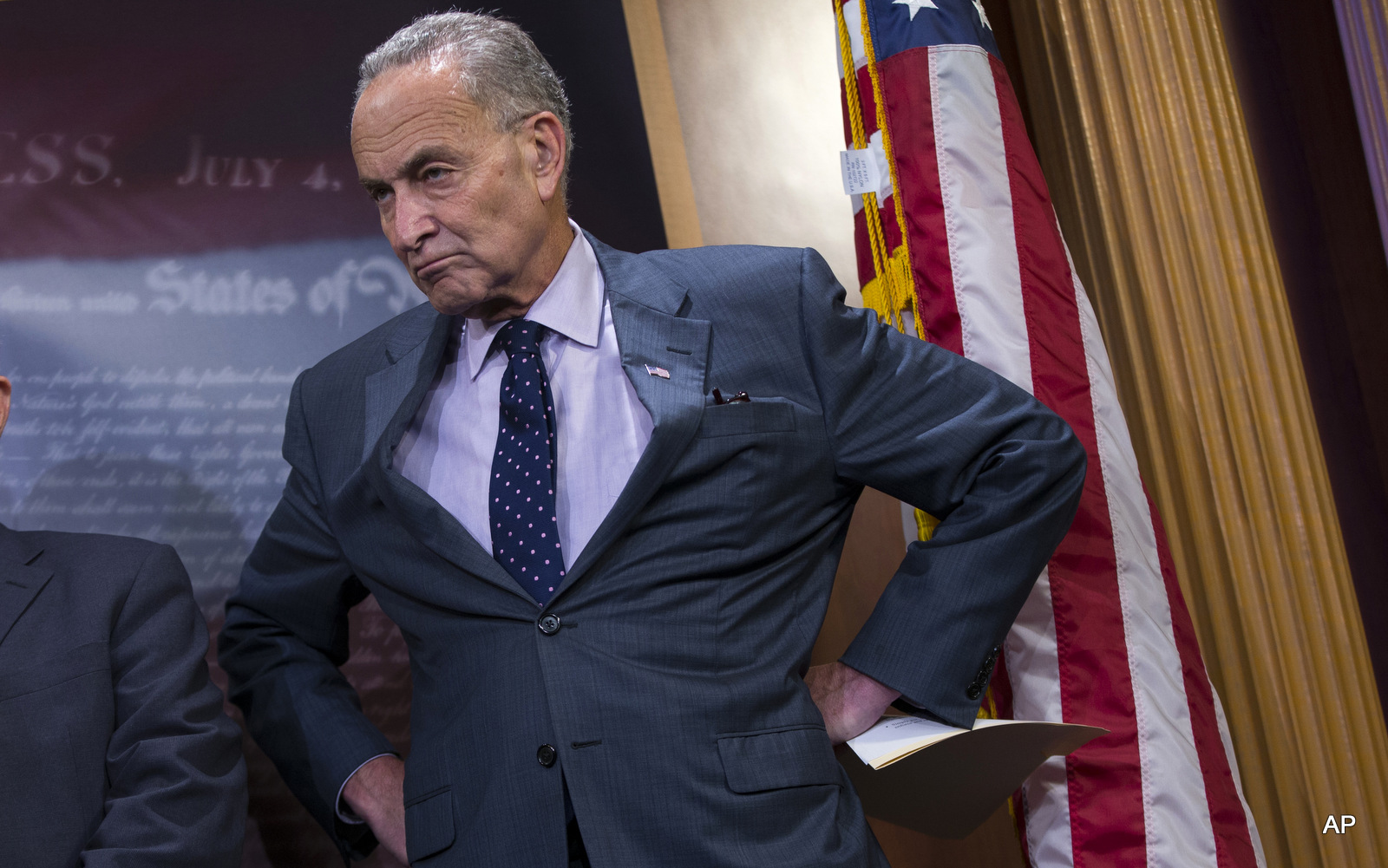 Sen. Charles Schumer, D-N.Y., right, accompanied by Sen. Ben Cardin, D-Md., listens during a news conference about legislation on Iran policy.