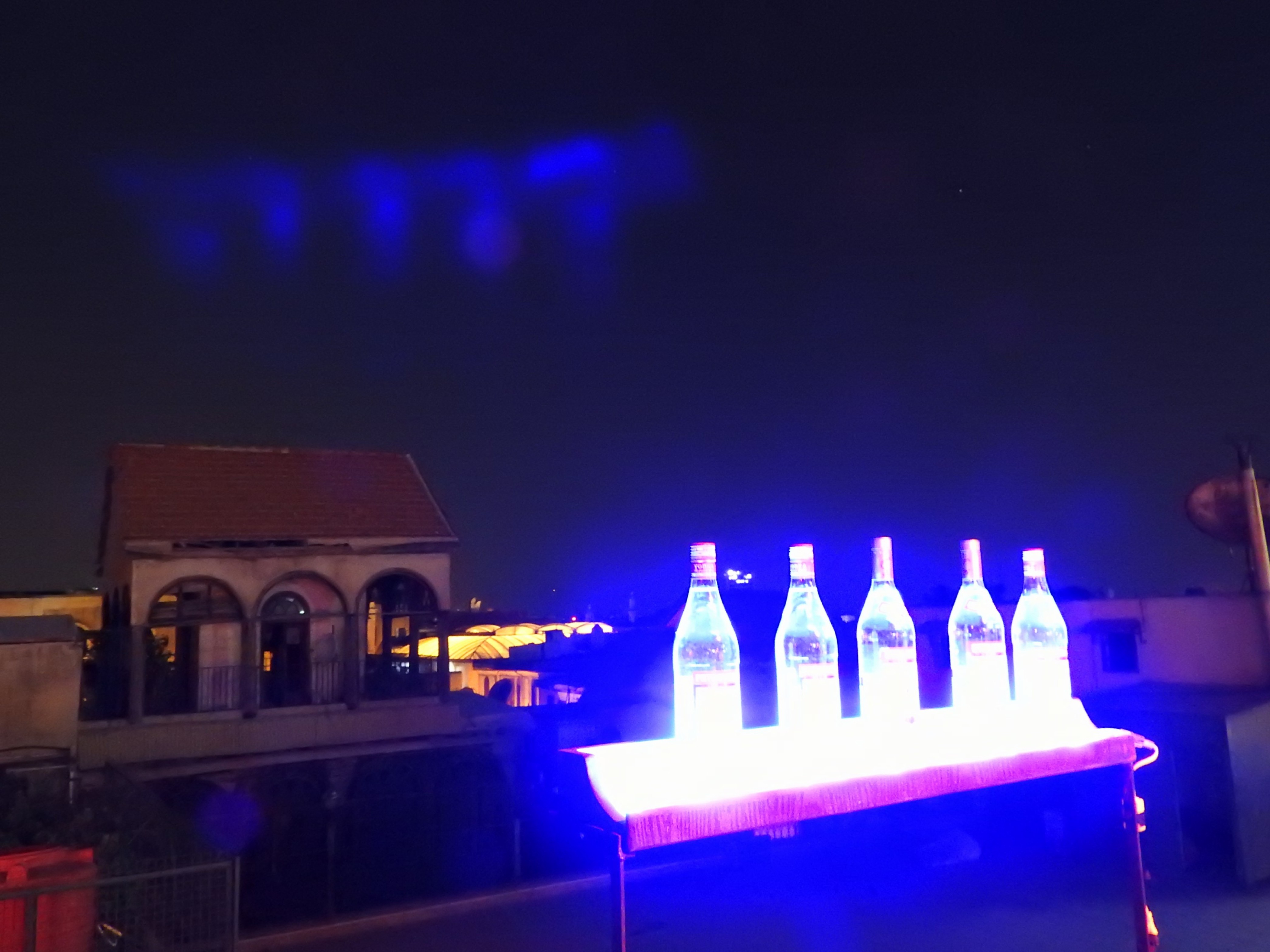  Le Visage, also in the East Gate quarter, was among the first outdoor establishment to open after the mortars stopped some months ago. From its rooftop position, one can look down on the historic Straight Street leading up to East Gate, as well as see life on balconies opposite, where months prior they were empty. A display of lighted alcohol bottles gleam in the dark, with Jobar less than 1 km beyond. A Damascus youth noted: “Imagine, ISIS are about 4 km away and we are opening new bars. This is the Syrian people.” 