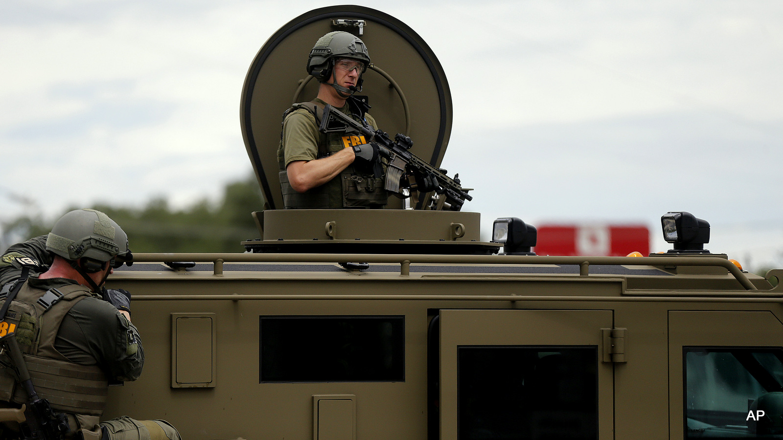 FBI patrol the perimeter of a crime scene in an armored vehicle in Baton Rouge, La., Sunday, July 17, 2016.