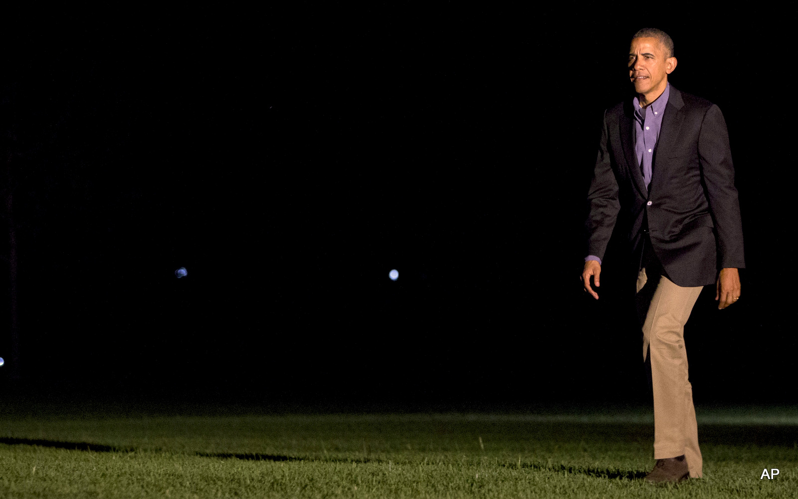 President Barack Obama returns from a shortened visit to Spain, as he walks across the South Lawn of the White House in Washington, Sunday, July 10, 2016.President Barack Obama returns from a shortened visit to Spain, as he walks across the South Lawn of the White House in Washington, Sunday, July 10, 2016.
