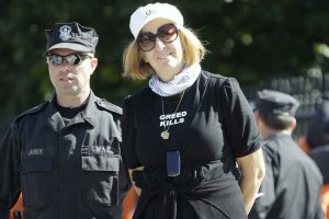 Cindy Sheehan is taken into custody by a United States Park Police officer during a demonstration in front of the White House in Washington, Monday, Oct. 5, 2009.