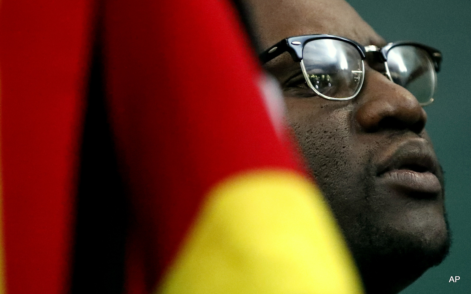Zimbabwean pastor Evan Mawarire, holds his country's flag whilst singing national anthem before addressing his supporters at the University of the Witwatersrand in Johannesburg, South Africa, Thursday, July 28, 2016. Mawarire, living in exile in South Africa after launching a social media campaign against President Robert Mugabe's government has called for a massive uprising against the country's government. 
