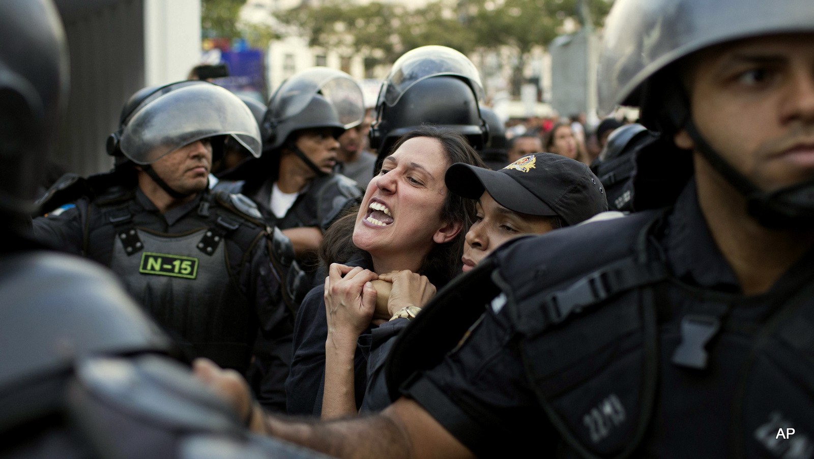 A demonstrator is taken away by riot police during a protest against the money spent on the Rio's 2016 Summer Olympics on the route of the olympic torch in Niteroi, Brazil, Tuesday, Aug. 2, 2016. The three-month torch relay across Brazil will end at the opening ceremony on Aug. 5, in Rio de Janeiro's Maracana stadium.