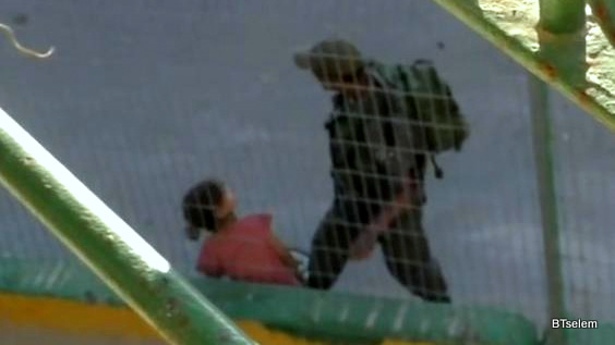 An Israeli border police officer was filmed taking eight-year-old Anwar Burqan's bicycle in Hebron on 25 July (B'Tselem)