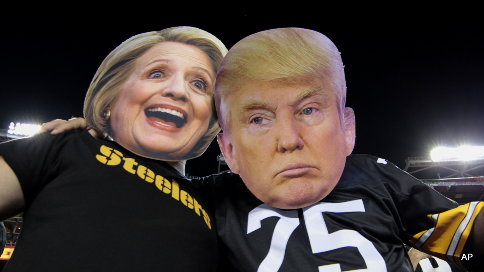 Pittsburgh Steelers fans Brian Picchini (left) and Rusty Kuchta (right) wear presidential candidates Sec. Hillary Clinton and Donald J. Trump masks during the first half of an NFL football game against the Washington Redskins in Landover, Md., Monday, Sept. 12, 2016.