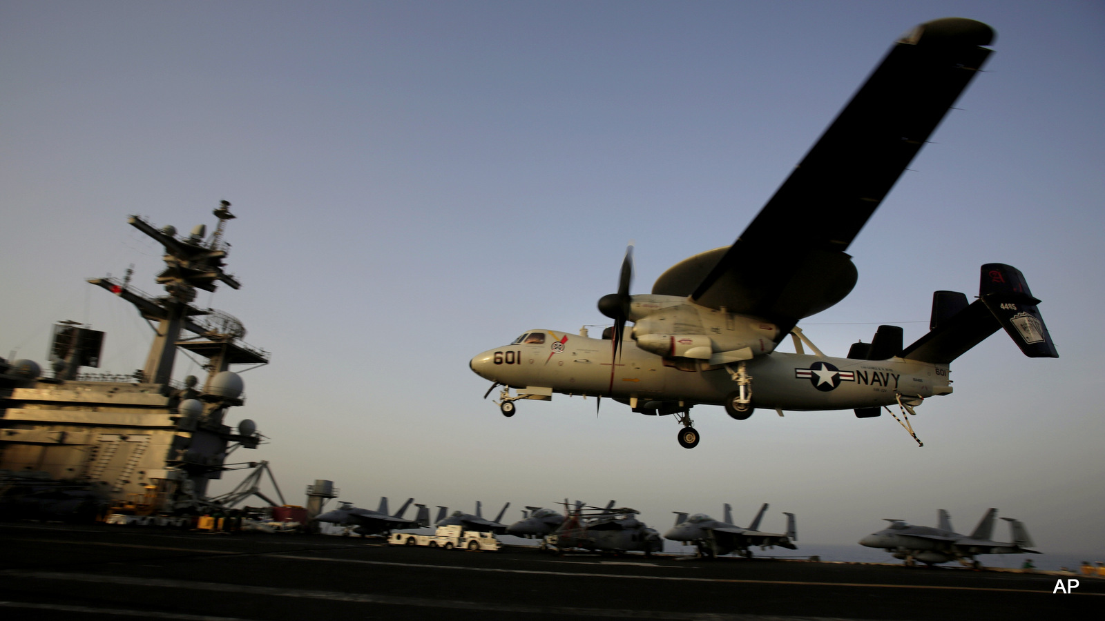 An aircraft lands after missions targeting the ISIS in Iraq from the deck of the U.S. Navy aircraft carrier USS George H.W. Bush in the Persian Gulf. For weapons manufacturers, the nonstop pace of airstrikes targeting ISIS fighters in Iraq and Syria, as well as Saudi-led bombing of Yemen’s Shiite rebels and their allies, means billions of dollars more in sales.