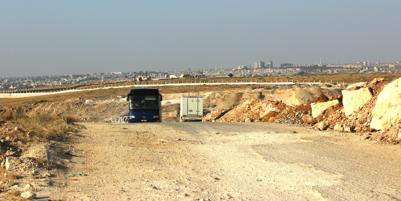 On the road out of Aleppo back to Damascus, we got out of the car to take one last photo of the city we were leaving behind us. (Photo: Vanessa Beeley)