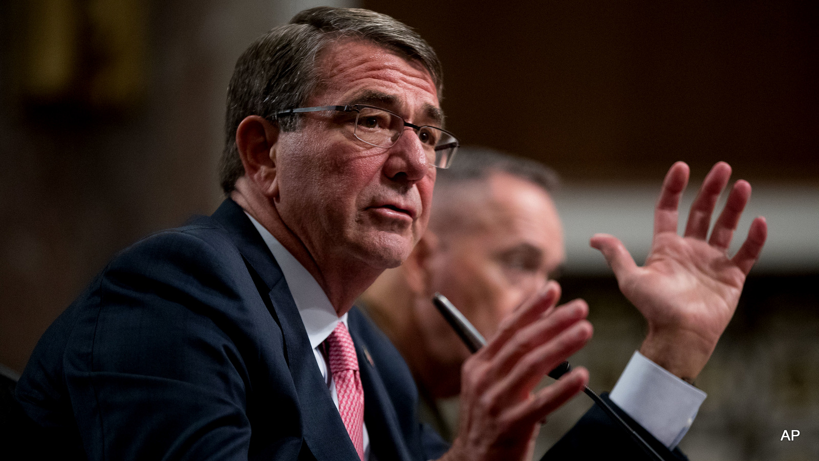 Defense Secretary Ash Carter, accompanied by Joint Chiefs Chairman Gen. Joseph Dunford, testifies on Capitol Hill in Washington.
