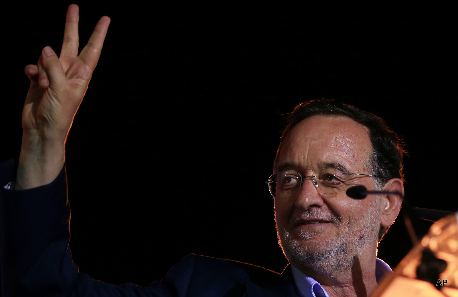 Panagiotis Lafazanis, former energy minister and head of the left-wing Popular Unity party, flashes the victory sign during a pre-election rally, in central Athens, Tuesday, Sept. 15, 2015. 