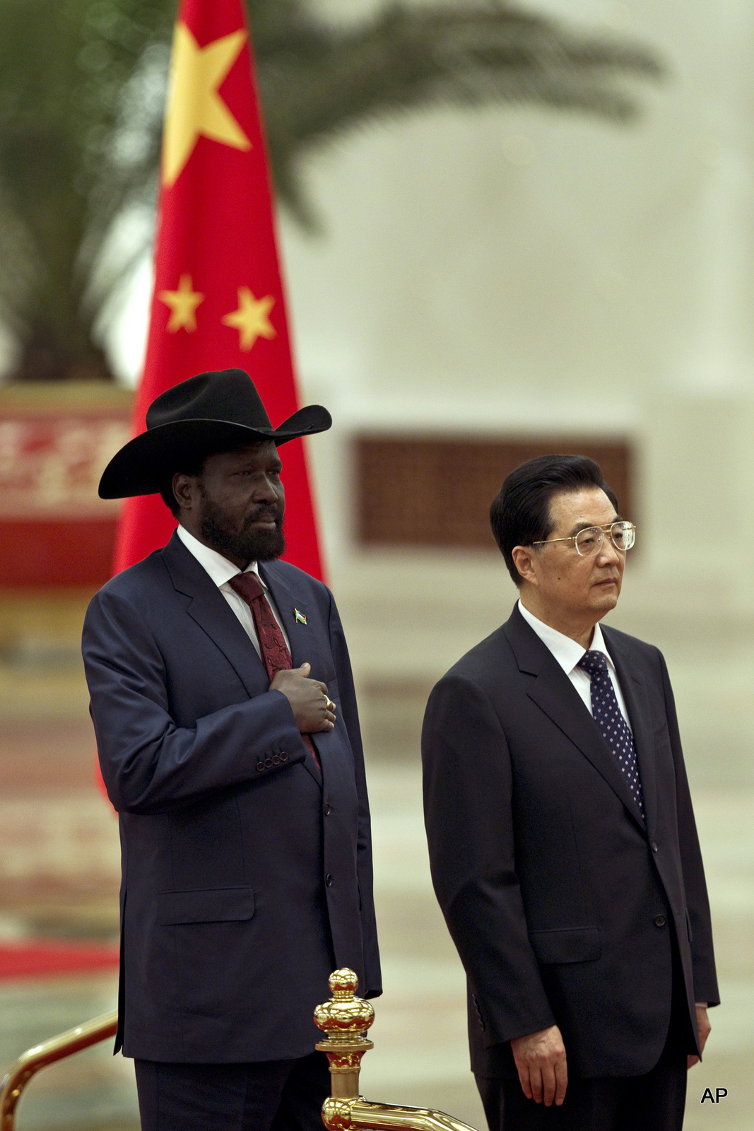 South Sudan's President Salva Kiir, left, stands with Chinese President Hu Jintao, while national anthems are played during a welcoming ceremony at the Great Hall of the People in Beijing, China, Tuesday, April 24, 2012.