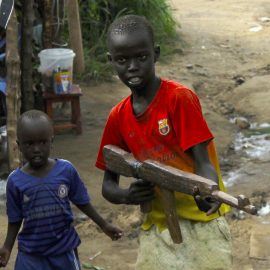 A group of children at the U.N. protection of Civilians site in Juba, South Sudan, play with a toy gun. President Barack Obama has issued waivers that continue U.S. military assistance for South Sudan and six other nations where child soldiers have been used.