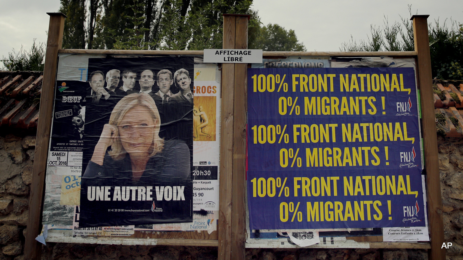 An electoral board showing France's far-right National Front president Marine Le Pen and reading: 100% National Front. 0% migrants is pictured during a demonstration in Forges-les-Bains, south of Paris, France, Saturday, Oct. 8, 2016.