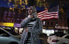 Enas Almadhwahi, an immigration outreach organizer for the Arab American Association of New York, stands for a photo along Fifth Avenue in the Bay Ridge neighborhood of Brooklyn, Friday, Nov. 11, 2016, in New York. American Muslims are reeling over Donald Trump's victory, wondering what the next four years will bring after a campaign in which he proposed creating a national database of Muslims, monitoring all mosques and banning some or all Muslims from entering the country. (AP Photo/Julie Jacobson)