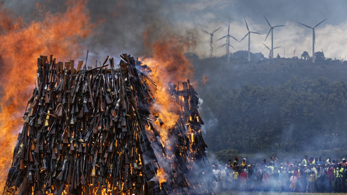 A pile of 5,250 illegal weapons are burned by Kenyan police in Ngong, near Nairobi, in Kenya Tuesday, Nov. 15, 2016. The weapons consisted of both confiscated and surrendered firearms that had been stockpiled over almost a decade and were destroyed by police as a message to the public to surrender others. (AP Photo/Ben Curtis)
