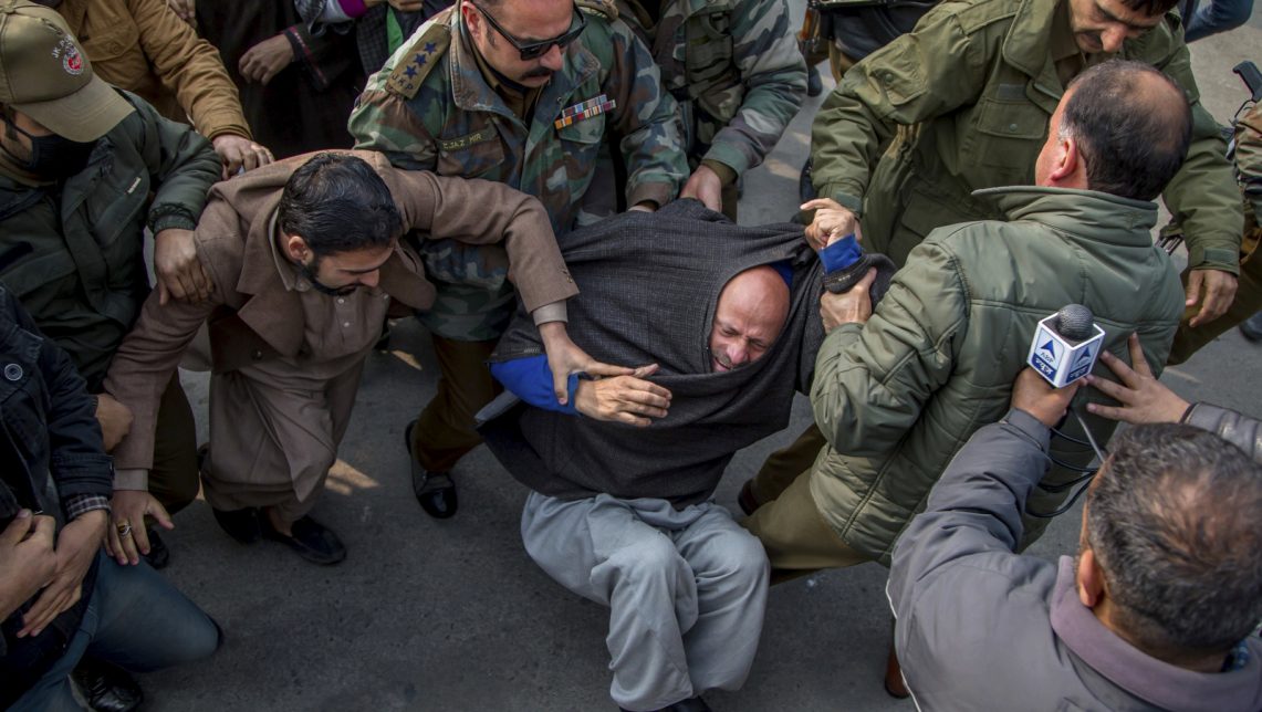 Indian policemen detain Jammu and Kashmir state's lawmaker, Engineer Abdul Rashid Sheikh, after he was stopped from offering prayers at the Grand Mosque in Srinagar, Indian controlled Kashmir, Friday, Nov. 18, 2016. Sheikh was detained after he and his supporters tried offering Friday prayers at the mosque. Indian government has banned people from offering prayers inside the mosque on Fridays for the past several weeks. (AP Photo/Dar Yasin)