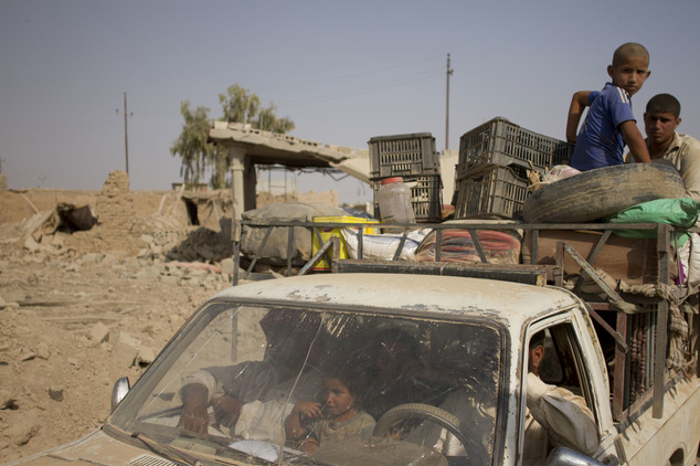 Civilians flee villages outside Mosul the day after Iraqi Kurdish forces launch an operation east of the Islamic State-held city in Iraq on Monday, Aug. 15, 2016. The Kurdish forces known as the Peshmerga say they have retaken 12 villages in the operation in an effort to encircle the city. (AP Photo/Susannah George)