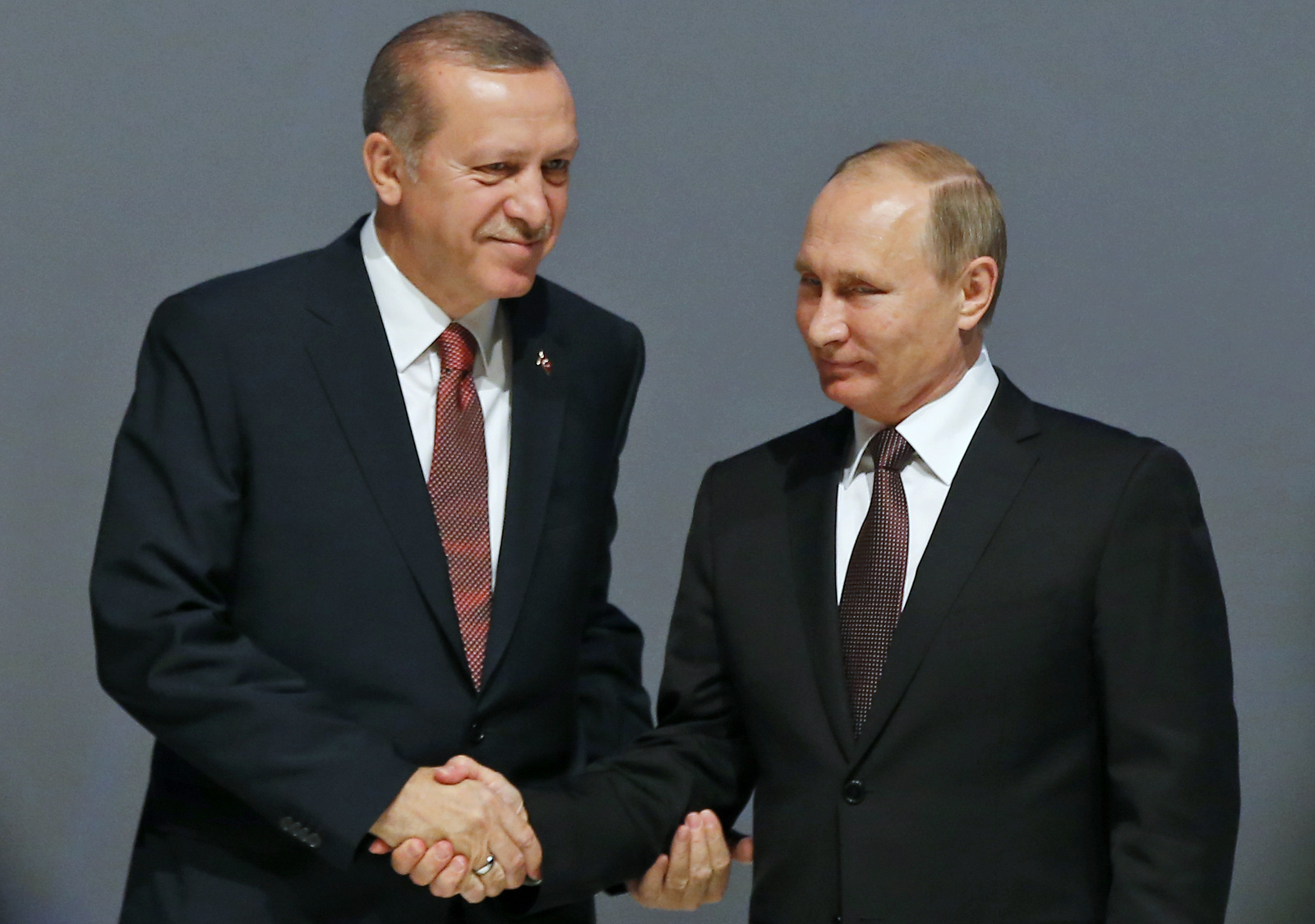 In this Oct. 10, 2016 photo, Turkey's President Recep Tayyip Erdogan, left and Russian President Vladimir Putin, shake hands following the group photo at the World Energy Congress, in Istanbul, Turkey. (AP/Emrah Gurel, File)