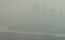 In this general view of London looking towards Canary Wharf which is just visible through the haze and smog in London, Friday, April 10, 2015. (AP/Alastair Grant)